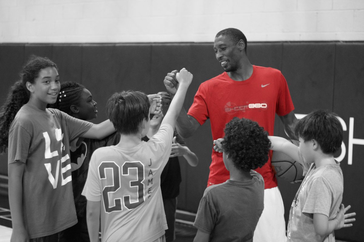Players huddled with a coach on the court