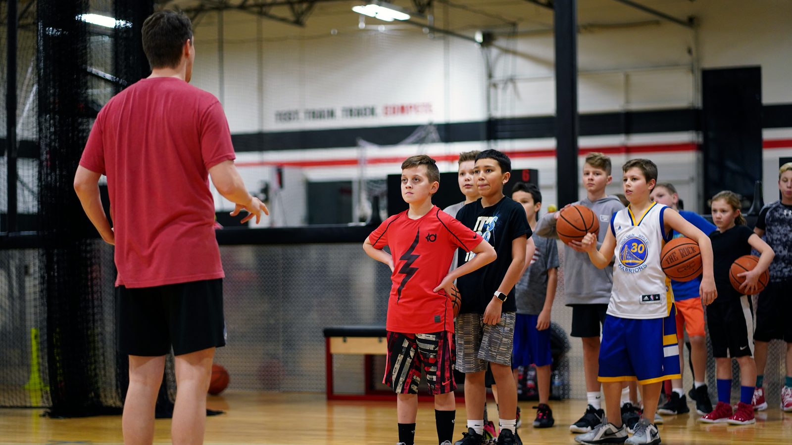 Coach leading a group of youth players through a drill